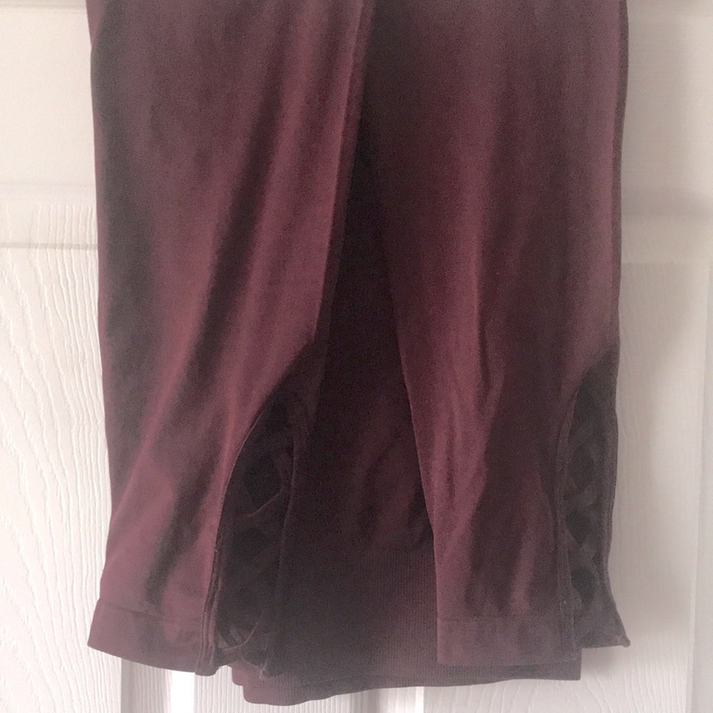 Wine colored leggings. Details on legs. One size
